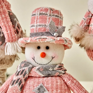 Pink and white knit Christmas snowman plush doll with plaid hat and patterned scarf