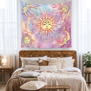Detailed view of bohemian sun and moon tapestry hanging above a wooden bed frame