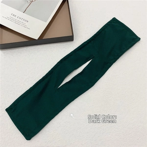 Detail of dark green hair bun maker tool made of fine fabric on a white texture base