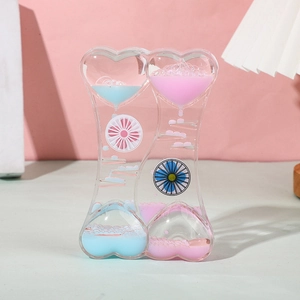 Detailed view of dual heart-shaped liquid motion timer with pink and blue oil droplets