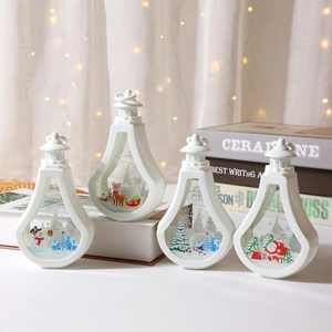 Detail of four white Christmas LED lanterns with festive reindeer and snowman patterns