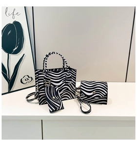 Detailed set of zebra print tote bag, crossbody bag, and coin purse with metal hardware