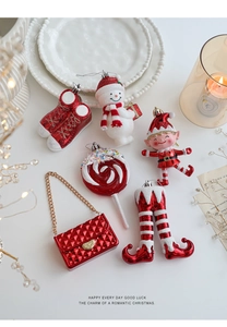 Close-up of red and white Christmas ornaments including snowman and candy cane shapes