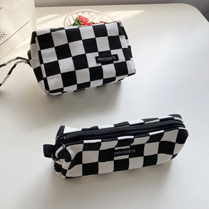 Detailed view of checkered canvas pouch set with merciparis label and metal ring zipper