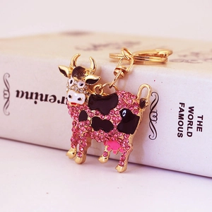 Cute pink rhinestone cow keychain charm with golden metal base for bags and accessories