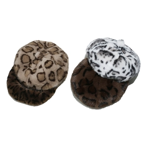 Detail of four faux fur berets featuring leopard and animal prints on white background