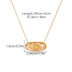 Detail view of oval shell pendant with gold sea shell motif and precise size dimensions
