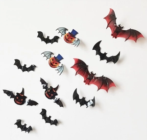 Detail showing various sizes of 3D Halloween bat and pumpkin wall stickers on white wall