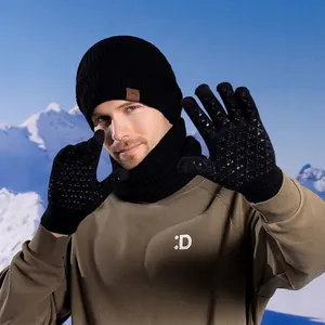 Winter men's 3-piece set with black knit beanie, scarf and gloves in snow mountain scenery