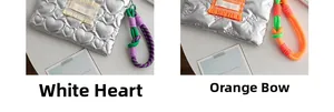 Detail of silver quilted pouches with heart and bow patterns featuring colorful lanyards
