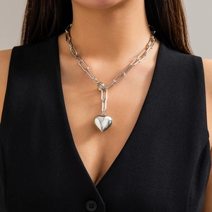 Minimalist silver paperclip link necklace with a 3D heart pendant on a female model