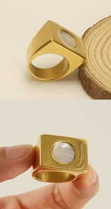 Detailed macro view of 18k gold-plated stainless steel ring with white mother-of-pearl inlay