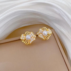 Elegant gold titanium steel hollow flower and leaf earrings with diamonds and pearls