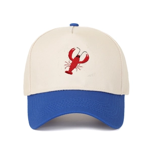 Detailed close-up of red lobster embroidery on a two-tone cotton baseball trucker hat