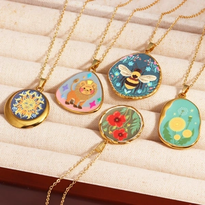 Detailed shot of vintage gold titanium necklaces with star and floral enamel pendants