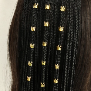 Ethnic style golden crown hair rings for braids and dreadlocks on black hair background