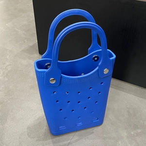 Close-up of blue EVA beach tote bag featuring circular laser-cut hollow holes and silver rivets