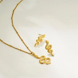 Golden snake jewelry set featuring a detailed pendant necklace and matching stud earrings