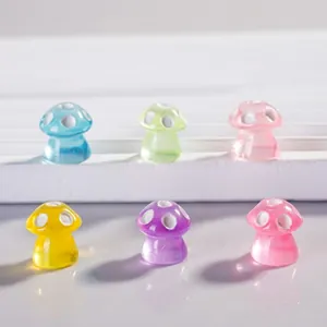 Macro shot of colorful translucent resin mushroom beads with white polka dots for DIY crafts