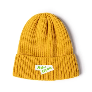 Vibrant yellow knit beanie featuring an Addition patch embroidery in a casual street style