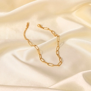 Gold titanium steel paperclip link anklet on elegant beige silk background with extension
