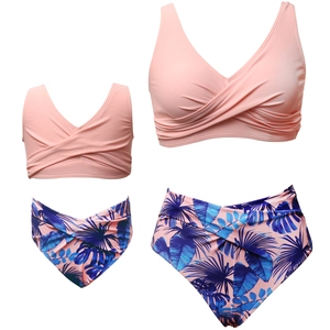 Flat lay of pink V-neck bikini sets with tropical leaf prints for mother and daughter