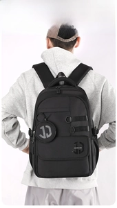 Rear view of black waterproof backpack showing multi-compartments and large capacity
