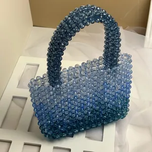 Close-up of handmade blue gradient acrylic beaded handbag with rounded top handle