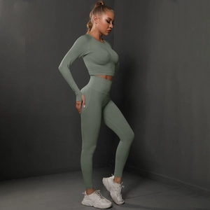 Side view of seamless knitted long sleeve crop top and high waist leggings in sage green