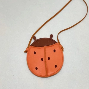 Cute orange ladybug crossbody bag for kids with realistic leather texture and antenna detail