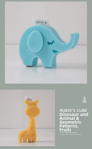 Detailed close-up of cute cartoon elephant and giraffe scented candles with brand tags