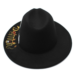 Detail of yellow Demon embroidery on a black wide brim wool felt fedora hat