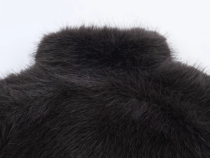 Close-up of premium dark faux fur material showing dense texture and soft fibers