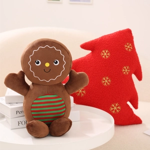 Close-up of a gingerbread man plush toy with festive red and green stripe accents