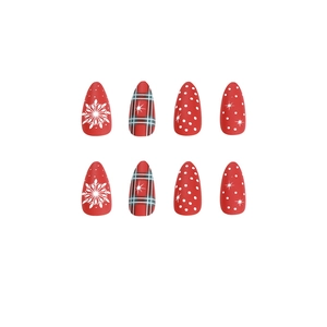 Christmas press-on nails with red patterns including snowflakes, plaid, and white polka dots