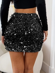 Close-up back view of elegant black sequin mini skirt with reflective glitter details