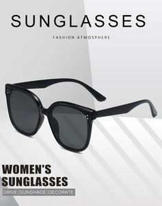 Detail view of stylish black oversized square sunglasses with elegant silver rivet accents