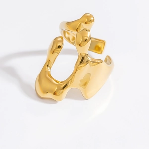 Close-up of golden irregular liquid metal ring with high-shine mirror finish surface