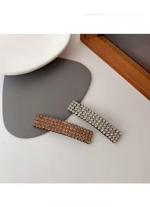 Close-up of elegant rectangular hair clips with champagne and clear pave-set rhinestones
