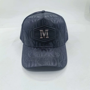 Detail of breathable mesh back and metallic M logo on a grey printed baseball cap