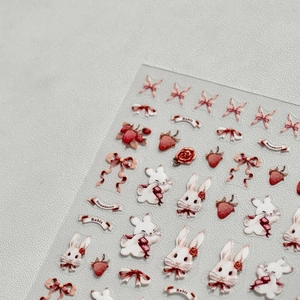 Japanese style nail art stickers featuring cute white rabbits and red glitter strawberries