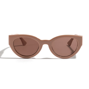 Retro cat-eye sunglasses in nude pink with brown tinted lenses on white background