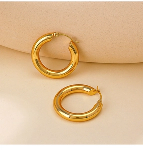 Close-up of polished 18K gold plated thick hoop earrings with a mirror-like finish