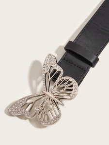 Close-up of sparkling rhinestone-encrusted butterfly buckle on a black leather belt