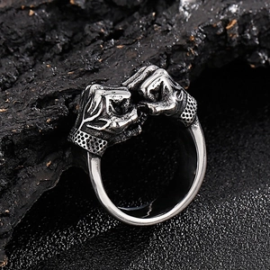 Vintage hip-hop double fist stainless steel ring for men on black stone background