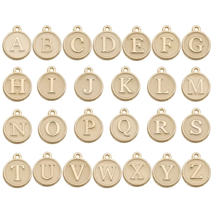 DIY jewelry charm set featuring 26 round metal alphabet pendants in cream white and gold