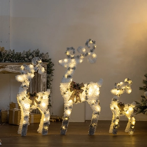 Three-piece set of lighted Christmas reindeer decor with warm LEDs and pinecone bows