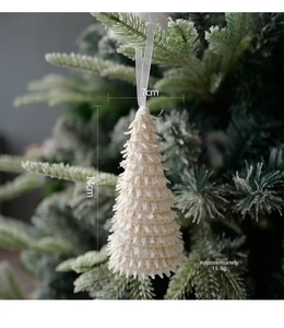 Close-up of a 14cm white flocked Christmas tree ornament hanging on a pine branch