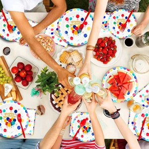 Flat lay of colorful balloon themed birthday tableware set with plates and napkins