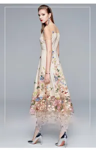 Close-up of colorful floral embroidery on beige mesh fabric for high-waist women dress